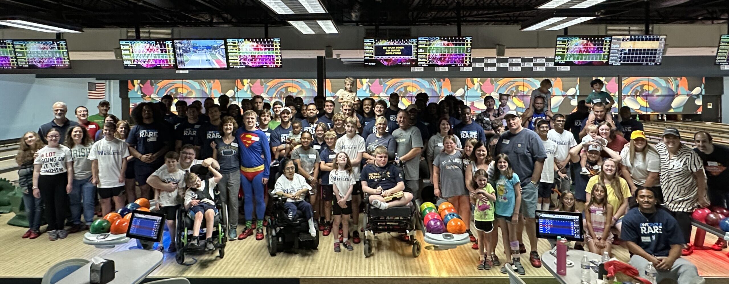 picture of people of all ages and abilities at a bowling alley